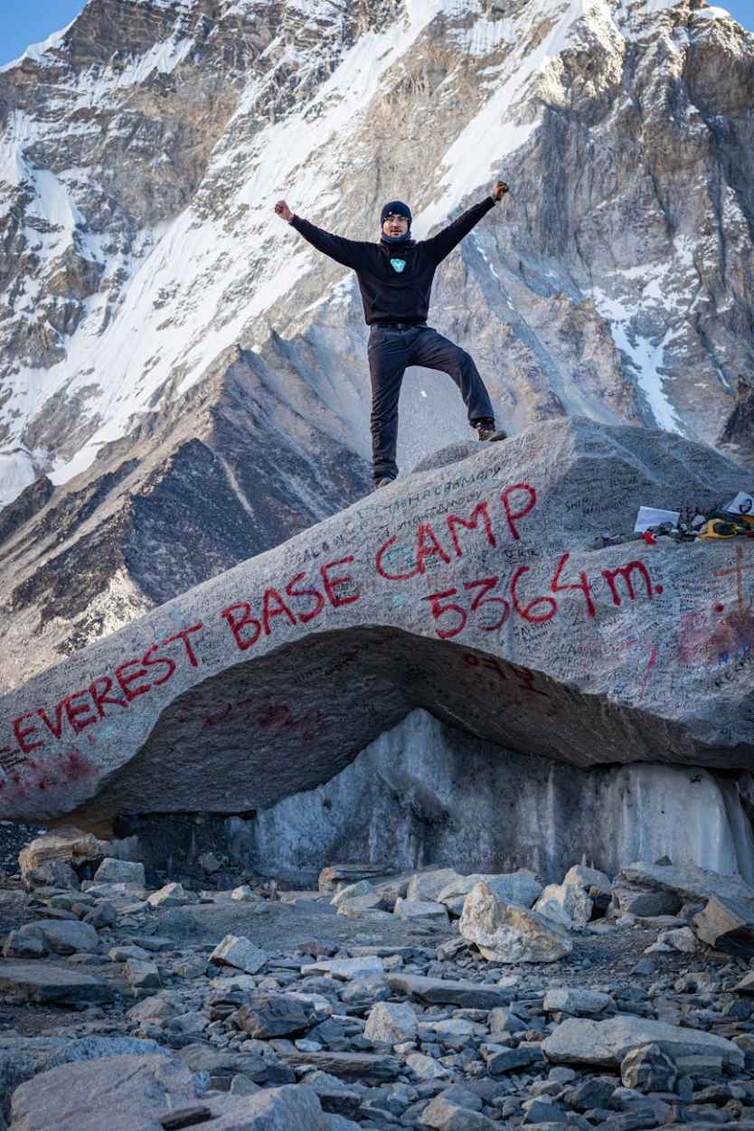 Everest Base Camp Billboard Removed After Trekker Backlash 2 a man standing on gray rock