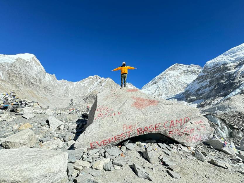 Nepal in Focus: A Photographer’s Guide to Capturing the Himalayas 3 mountaineer posing on a rock at the everest base camp